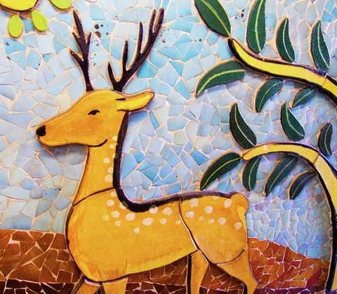 A yellow deer with dark antlers and white spots stands against a colorful tiled mosaic of foliage.