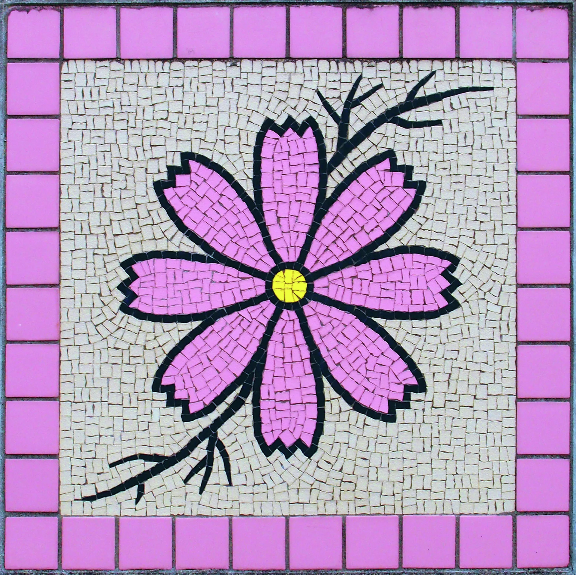 A pink flower with a yellow center and dark branching stems fills a pink-bordered mosaic panel.
