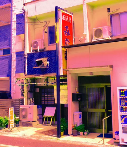 Pink and blue walls frame small shop entrances beneath air conditioners and a tall red Japanese sign.