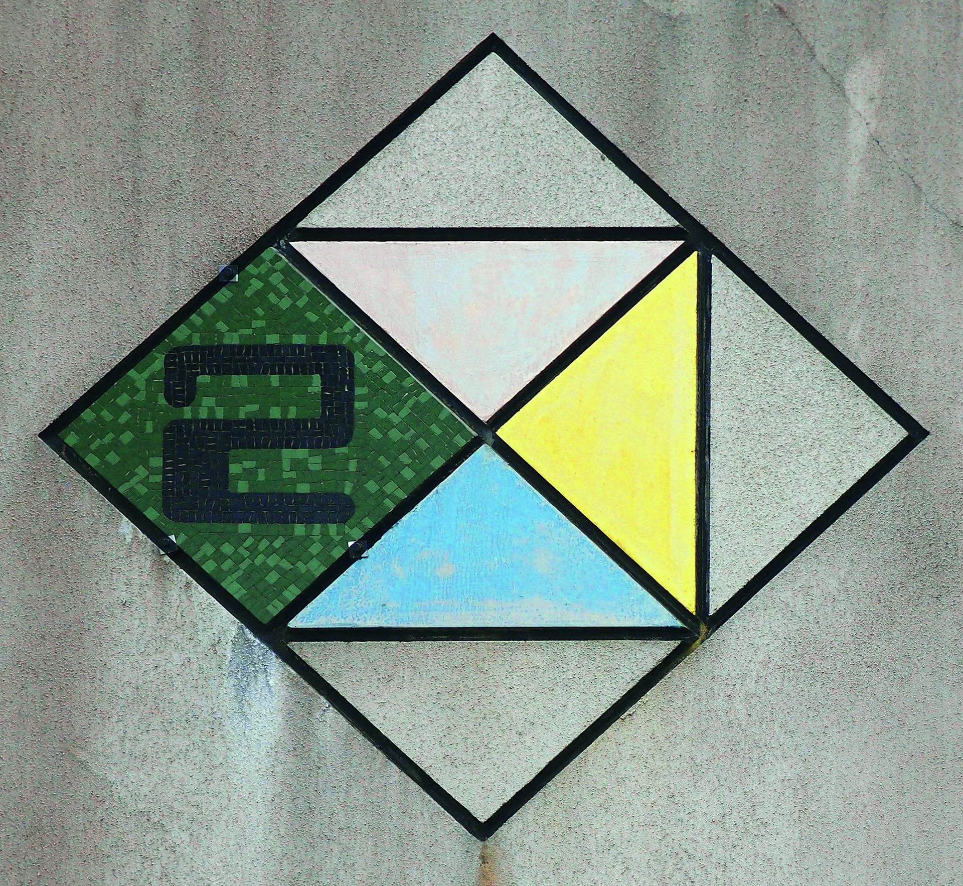 Black outlines divide a diamond mosaic into green, blue, yellow, and pale triangular sections.