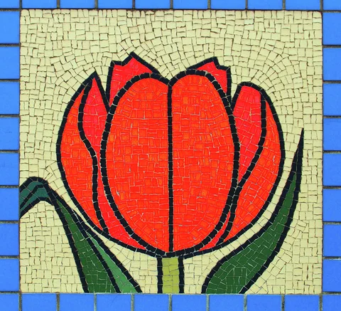 A red tulip mosaic rises between dark green leaves within a bright blue tile border.