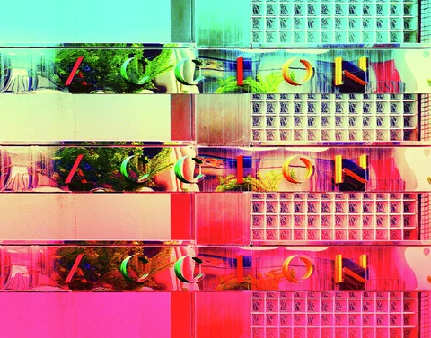 Three repeated bands of colorful lettering and reflections alternate with glass blocks in turquoise, yellow, and pink.