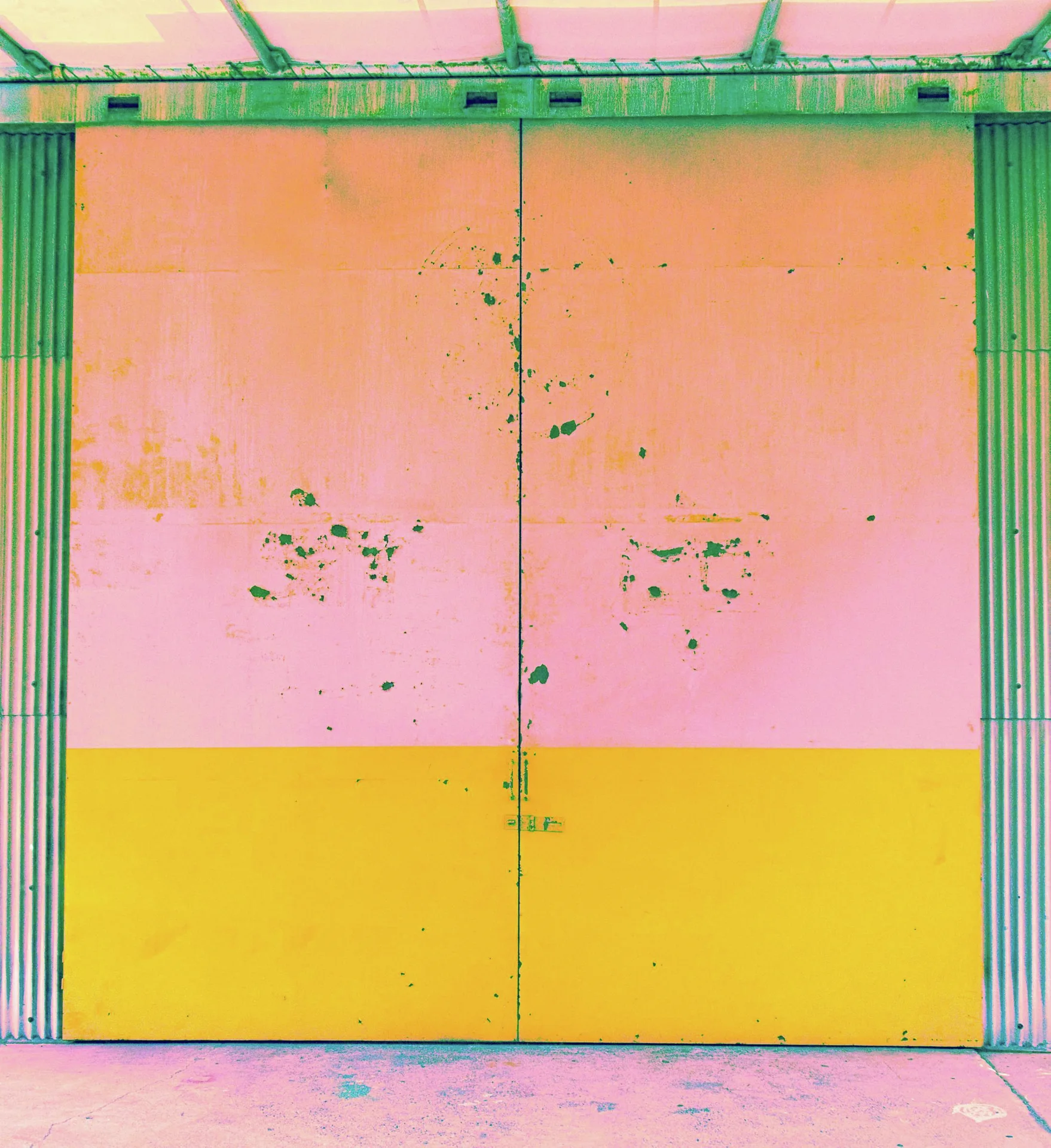 A worn double metal door has pink upper panels and a bright yellow lower band.