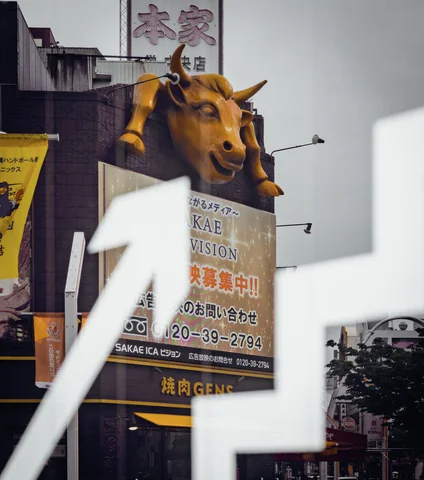 A golden horned animal head projects above a restaurant sign behind large pale foreground window markings.