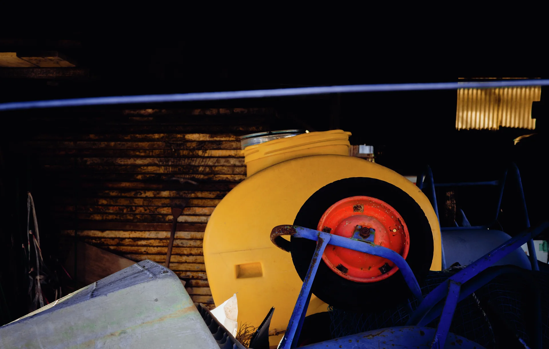 A large yellow circular machine housing with a red center sits among blue equipment in a dark interior.