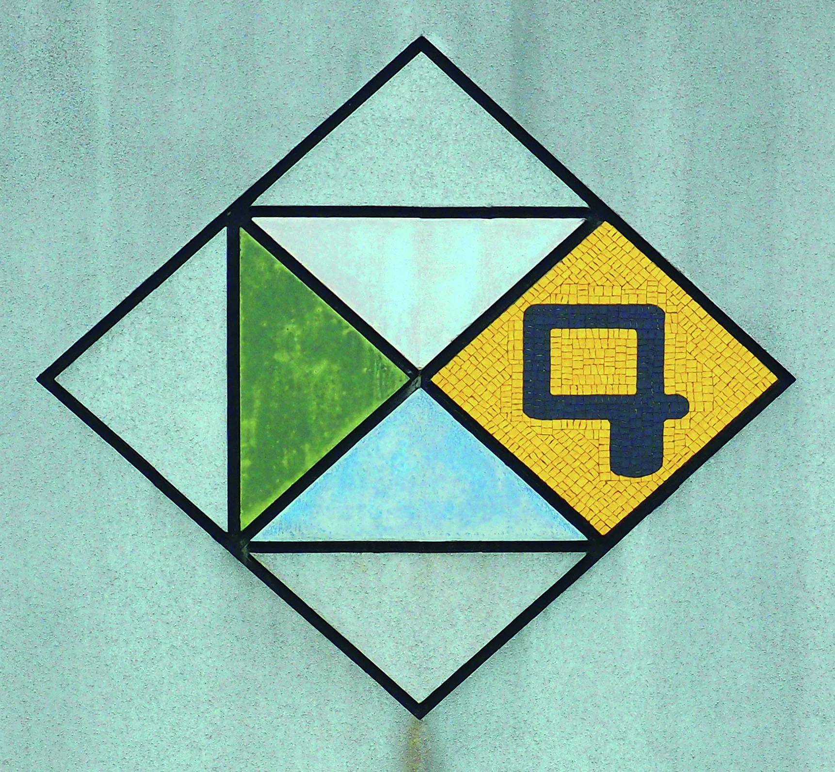 A diamond wall emblem contains green and blue triangles beside a dark numeral four on yellow mosaic.